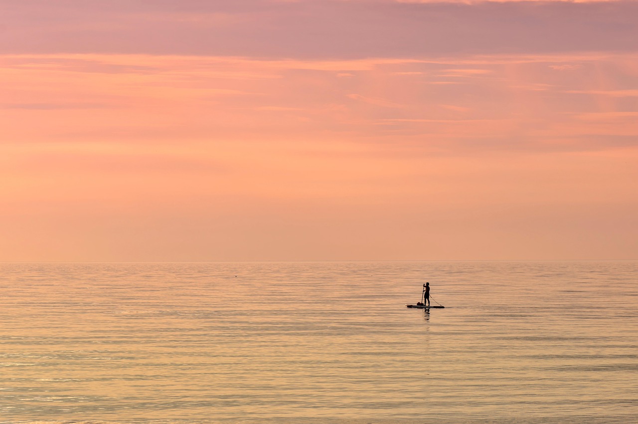 Sea, paddle boarding, sunset — Kevin Sumlin Influencing Modern Coaching With Experience-Based Strategies